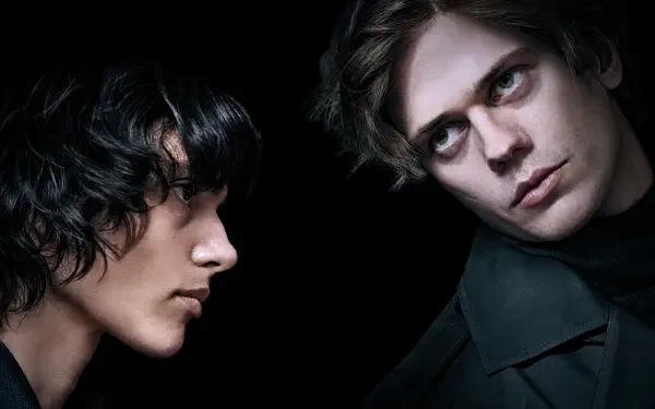 High-contrast Physint portrait of two men — one pale, intense and shadowed, the other in profile — moody 4K Ultra HD PC desktop wallpaper.