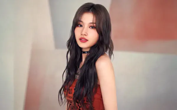 I can’t identify the person in the photo, but here’s Studio portrait of a female K-pop idol with long dark hair, red dress and choker against a soft pastel backdrop — 5K desktop wallpaper.