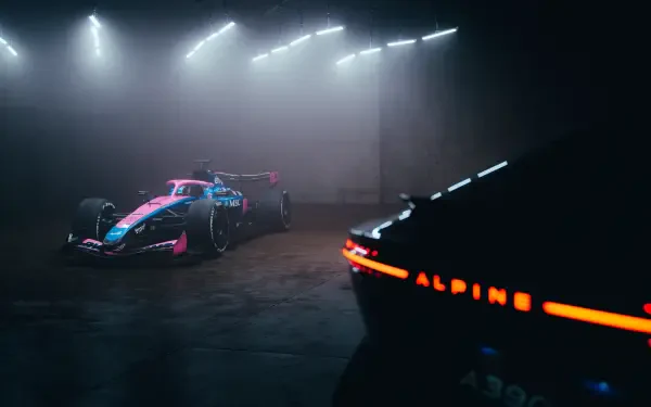 Alpine A526 F1 race car in a dramatic dark studio, featured in an 8K Ultra HD PC desktop wallpaper and background.