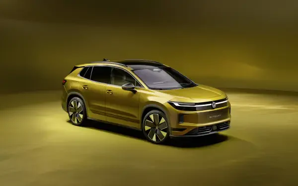 Gold Volkswagen ID. Tiguan SUV in a dramatic studio setting, 4K Ultra HD PC desktop wallpaper