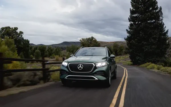 Mercedes-Benz GLS SUV driving a scenic rural road, HD PC desktop wallpaper and background.