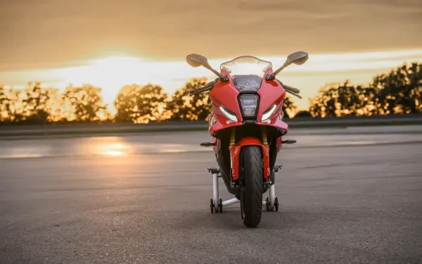 Red BMW Motorrad F 450 RR sport bike facing forward at sunset, 8K Ultra HD desktop wallpaper and background.
