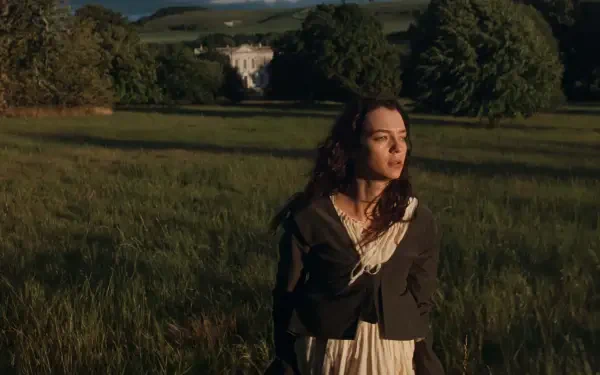 Daisy Edgar-Jones in Sense and Sensibility stands in a sunlit countryside meadow, with a grand estate in the distance—HD desktop wallpaper.
