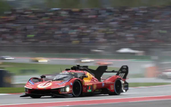 Ferrari 499P race car speeding past grandstands, featured in a 4K Ultra HD PC desktop wallpaper and background.