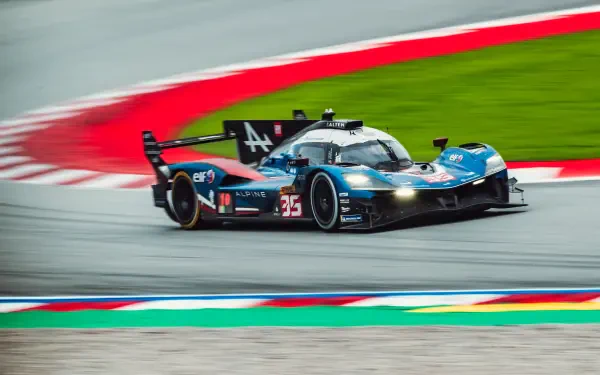 Alpine A424 race car speeding around a race track in motorsport action, featured in a 5K Ultra HD PC desktop wallpaper background.