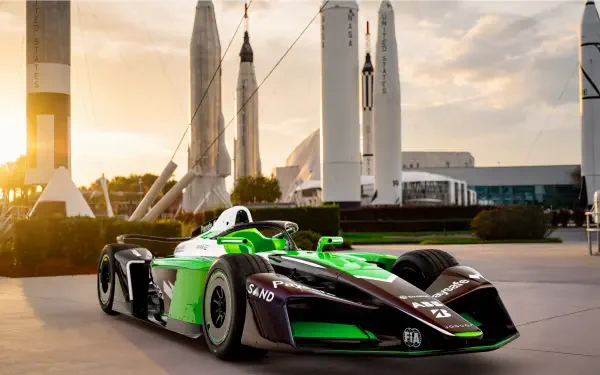 Envision Racing Formula E electric race car at sunset, 8K Ultra HD desktop wallpaper and background.