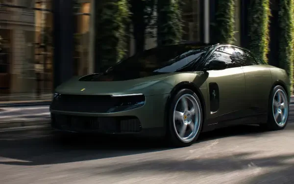 Dark green Ferrari Luce luxury sports car driving past a city park, featured in a 4K Ultra HD PC desktop wallpaper and background.