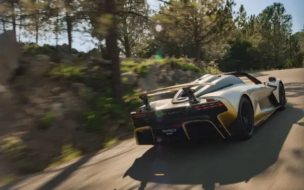 Aston Martin Valhalla Spider supercar driving on a wooded road, rendered as an 8K Ultra HD PC desktop wallpaper.