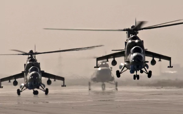 Three Mil Mi-35 helicopters take off from a runway, showcasing military power in this striking HD desktop wallpaper. A bold image capturing motion and strength.