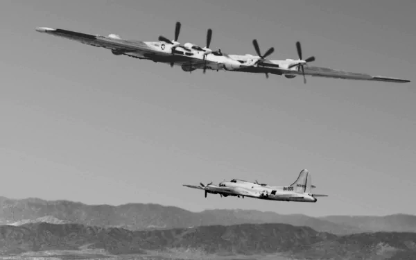 Black-and-white HD PC desktop wallpaper and background showing two military Northrop YB-35 flying-wing bombers in formation over rugged mountains.