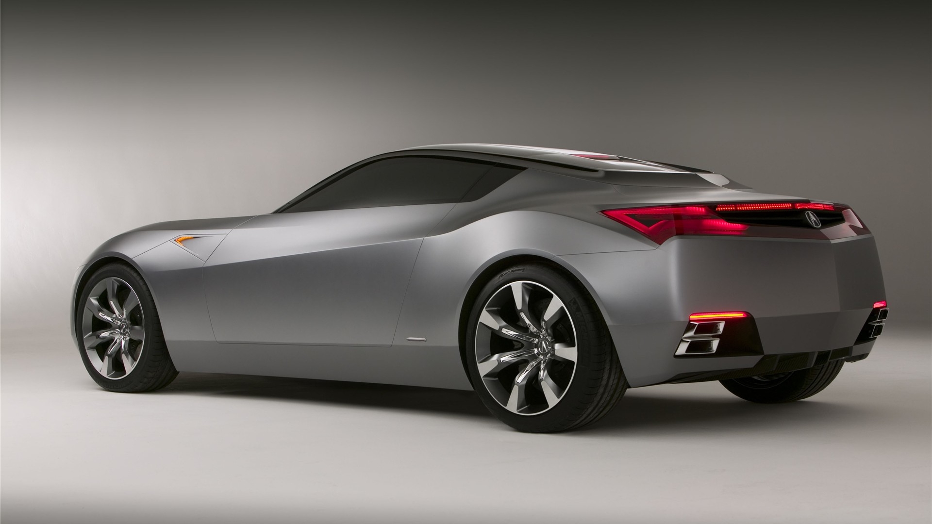 Acura Advanced Sedan Concept showcased amidst a scenic backdrop; a stylish and sleek vehicle evoking elegance and power.