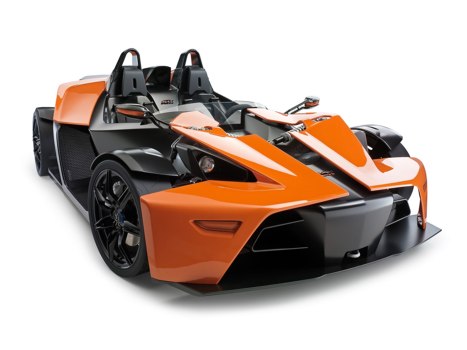 HD PC desktop wallpaper featuring a sleek orange and black KTM X-Bow sports vehicle with an open cockpit design.