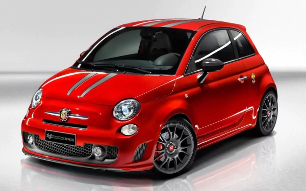 HD PC desktop wallpaper showing a red Fiat 500 vehicle with sporty stripes and alloy wheels, glossy studio reflection on a clean white background.