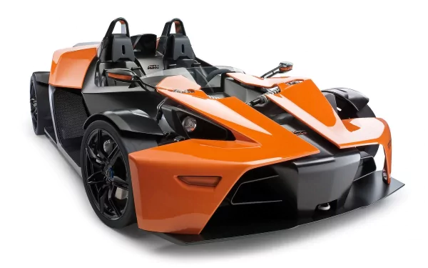 HD PC desktop wallpaper featuring a sleek orange and black KTM X-Bow sports vehicle with an open cockpit design.