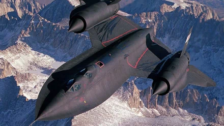 A striking HD image of the Lockheed SR-71 Blackbird soaring over mountain ranges, showcasing its sleek design as a pioneer in military aircraft technology.