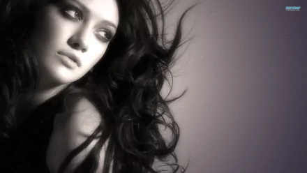 HD PC desktop wallpaper featuring a close-up black-and-white portrait of celebrity Hilary Duff with flowing hair and a contemplative expression.