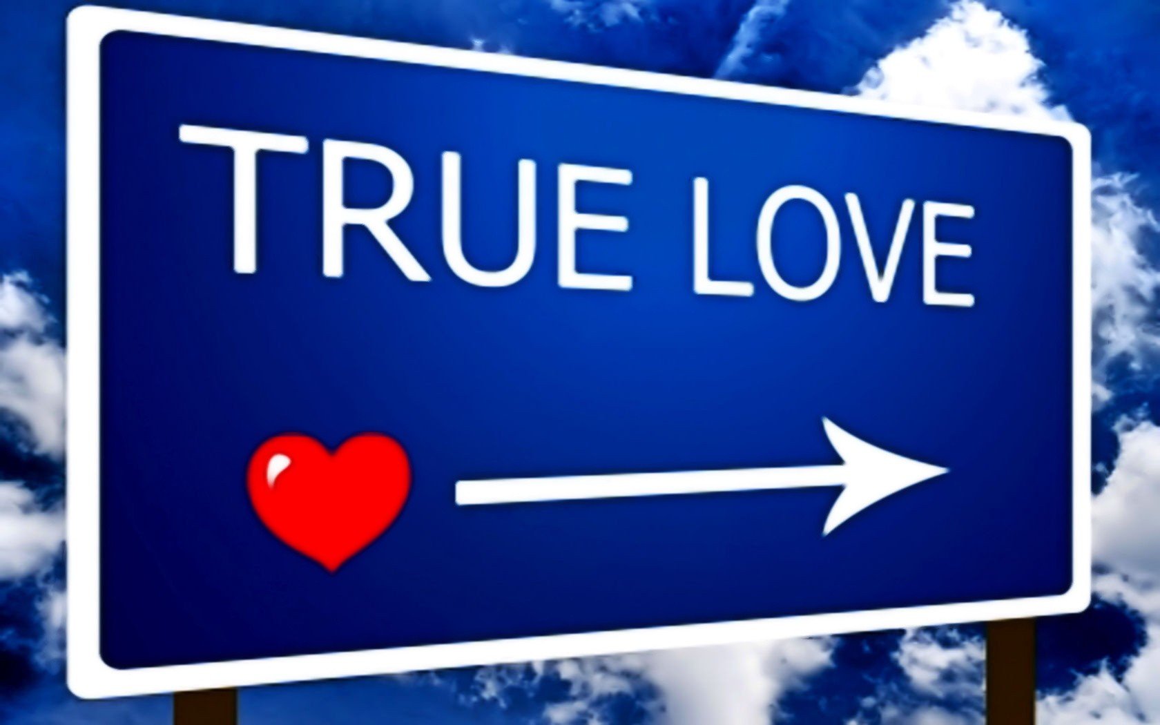HD PC desktop wallpaper of a blue road sign with a red heart and white arrow pointing right, displaying the words TRUE LOVE against a bright, cloudy sky background.