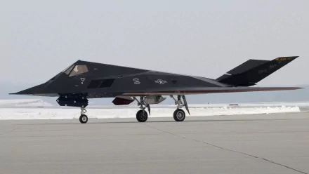 A sleek military stealth aircraft on the runway, showcasing its advanced design and technology. This HD image serves as a striking desktop wallpaper and background.