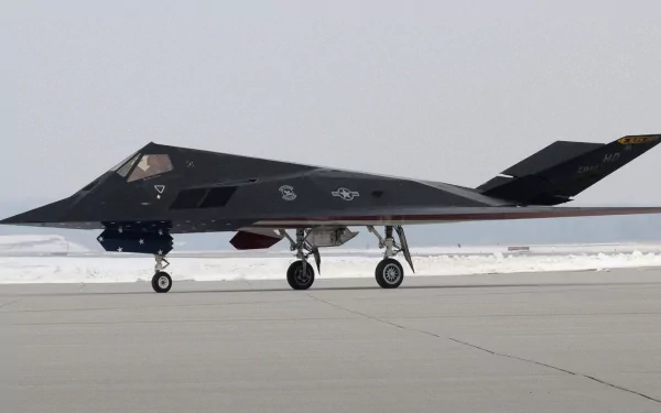A sleek military stealth aircraft on the runway, showcasing its advanced design and technology. This HD image serves as a striking desktop wallpaper and background.