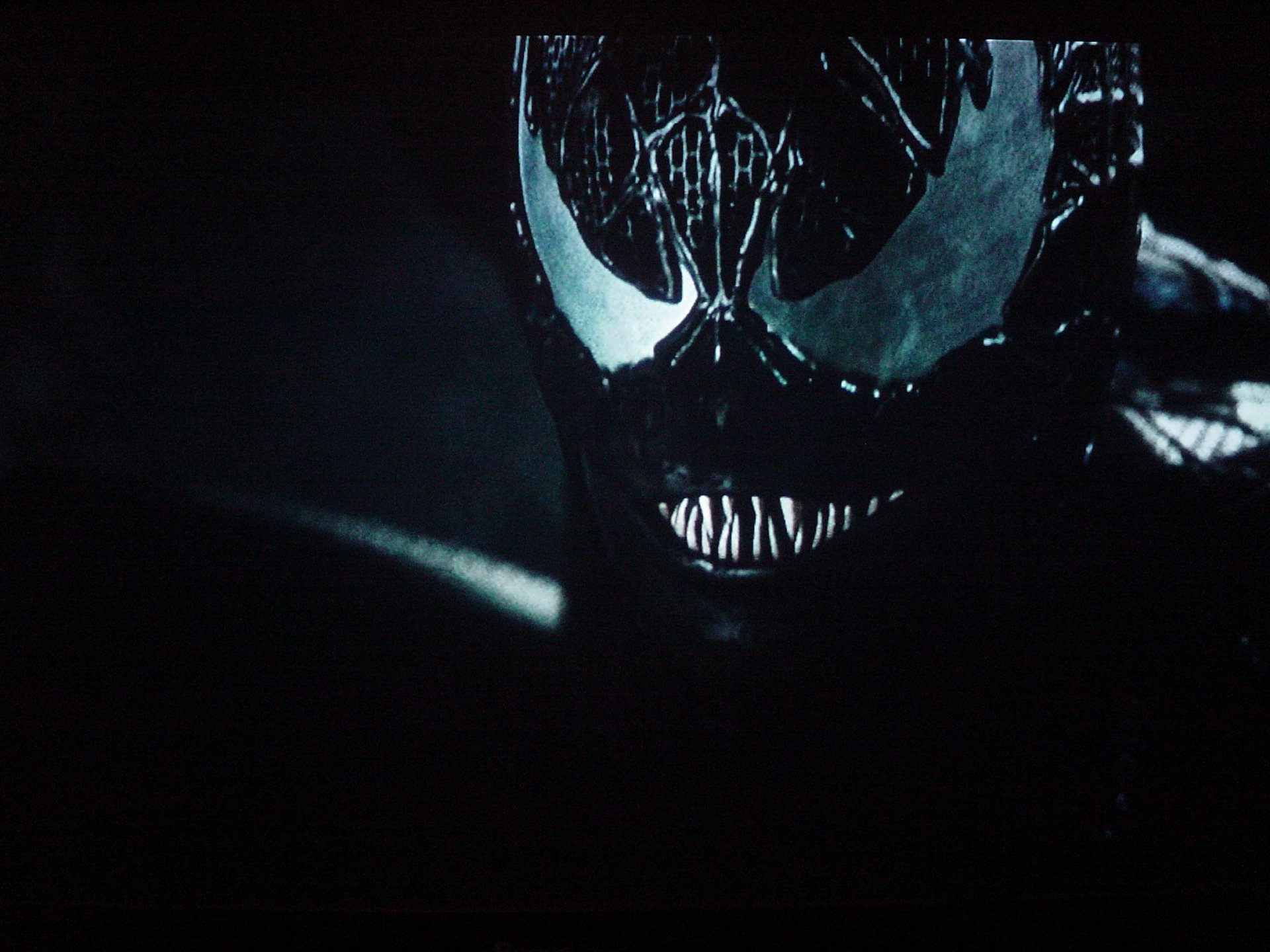 A dark and striking HD wallpaper featuring Venom from the movie Spider-Man 3, showcasing the character's menacing visage against a shadowy background.