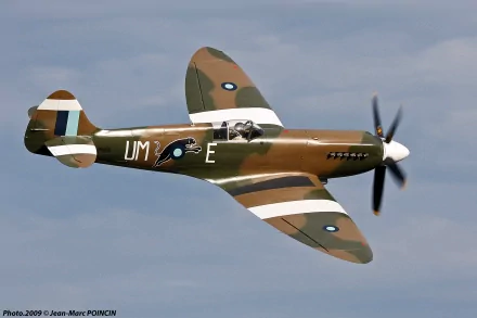 HD desktop wallpaper of a vintage military aircraft flying against a cloudy sky, showcasing its detailed camouflage and markings.
