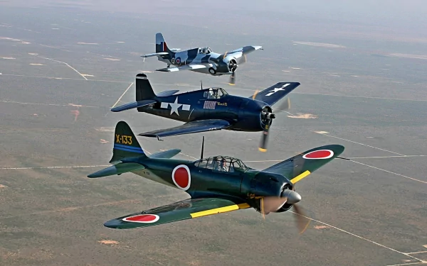 A stunning HD desktop wallpaper featuring three military jet fighters in flight, highlighting their distinctive designs against a vast landscape.