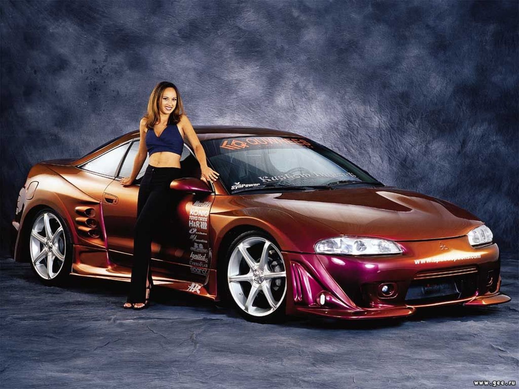 HD PC desktop wallpaper featuring a sleek, modified sports car and a woman, inspired by the video game Need For Speed.