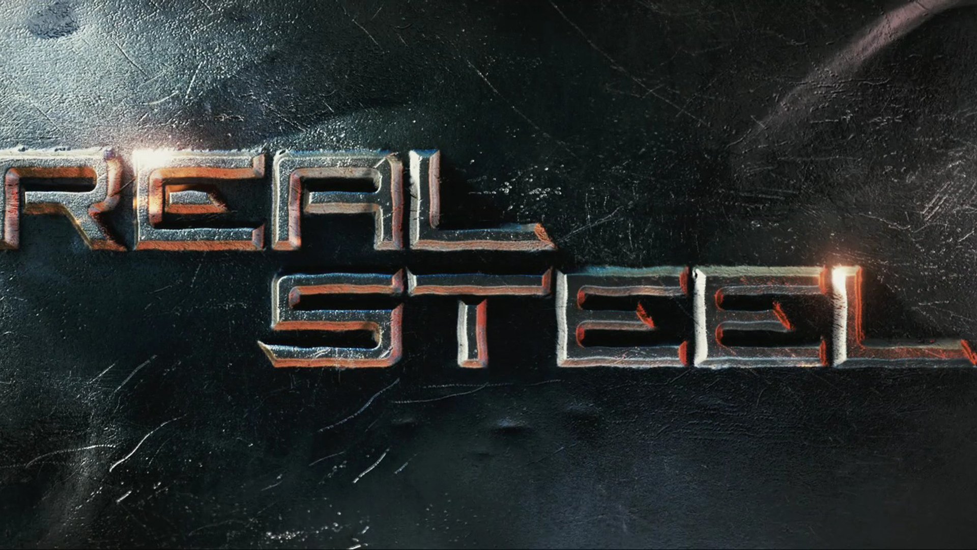 HD PC desktop wallpaper featuring the metallic Real Steel movie logo on a dark, textured background.