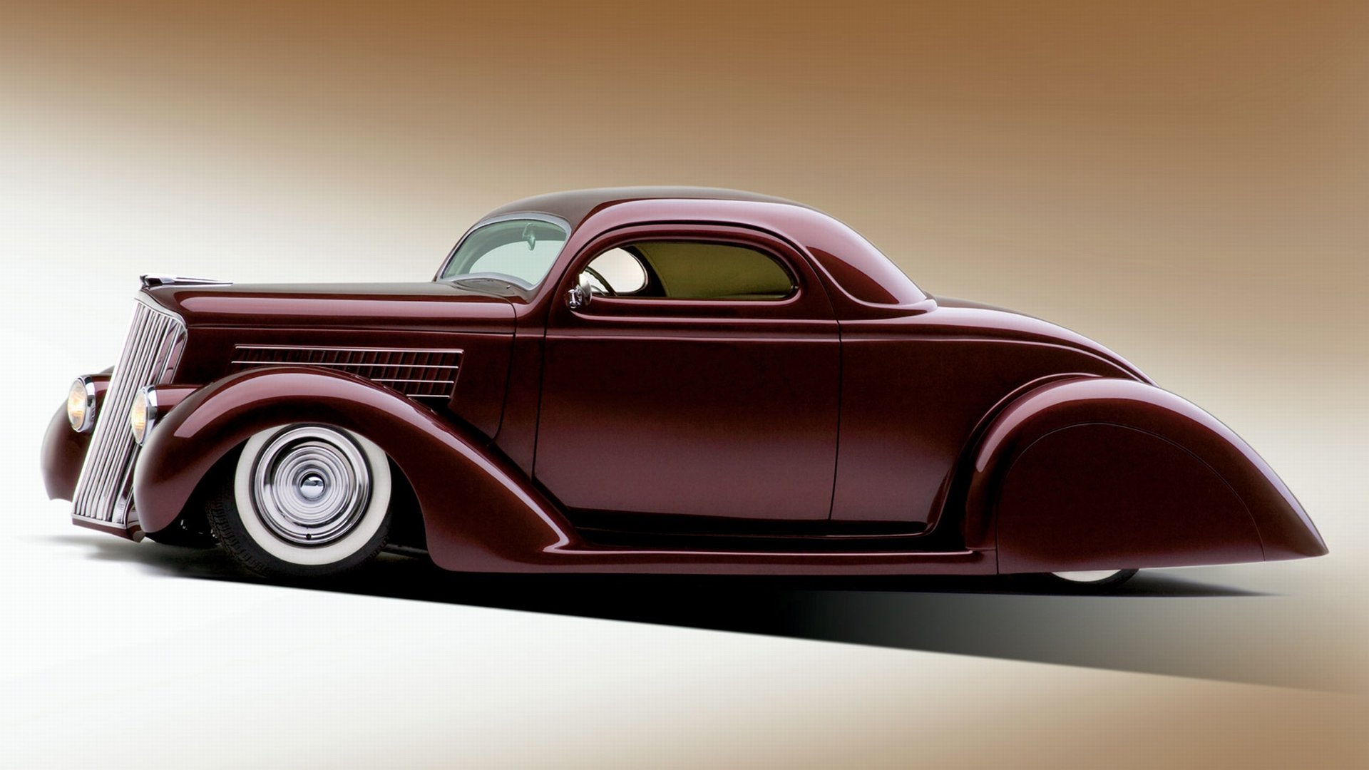 A sleek, deep burgundy 1935 Ford Custom with smooth lines and lowered stance, featured as an HD desktop wallpaper and background.