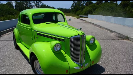 Bright green 1938 Dodge Brothers Business Coupe parked on a sunlit road, captured in HD for a vivid PC desktop wallpaper background.