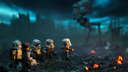 A stunning HD wallpaper featuring Lego Stormtroopers from the Star Wars universe, set against a dramatic, fiery landscape with a towering AT-AT in the background.