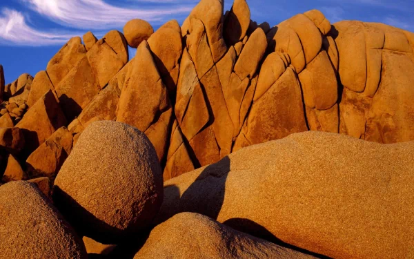 A stunning view of rock formations in Joshua Tree National Park, California, showcasing the unique desert landscape under a clear blue sky.