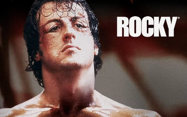 HD desktop wallpaper of the movie Rocky featuring a close-up of the protagonist, glistening with sweat, against a blurred background.