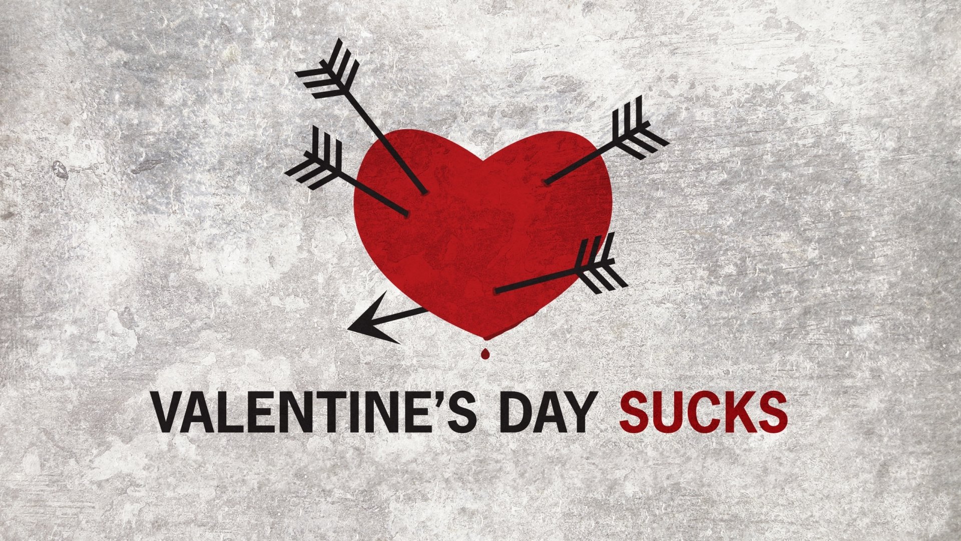 Funny Valentine's Day 2K Quad HD PC desktop wallpaper: distressed red heart pierced by arrows above bold text VALENTINE'S DAY SUCKS on a gray textured background.