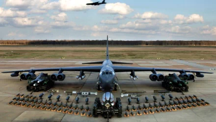 HD desktop wallpaper featuring a Boeing B-52 Stratofortress aircraft on the runway with military vehicles and equipment arranged symmetrically around it.
