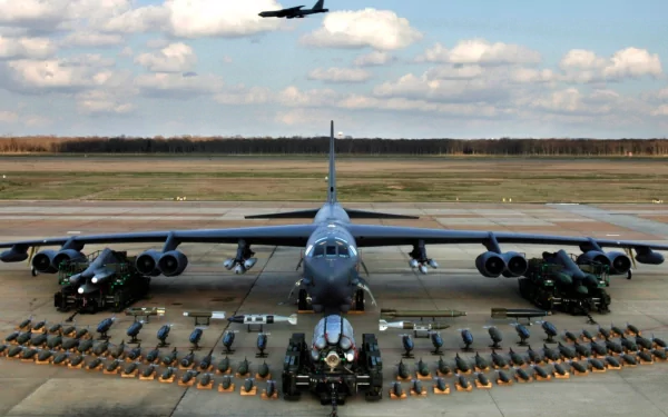 HD desktop wallpaper featuring a Boeing B-52 Stratofortress aircraft on the runway with military vehicles and equipment arranged symmetrically around it.