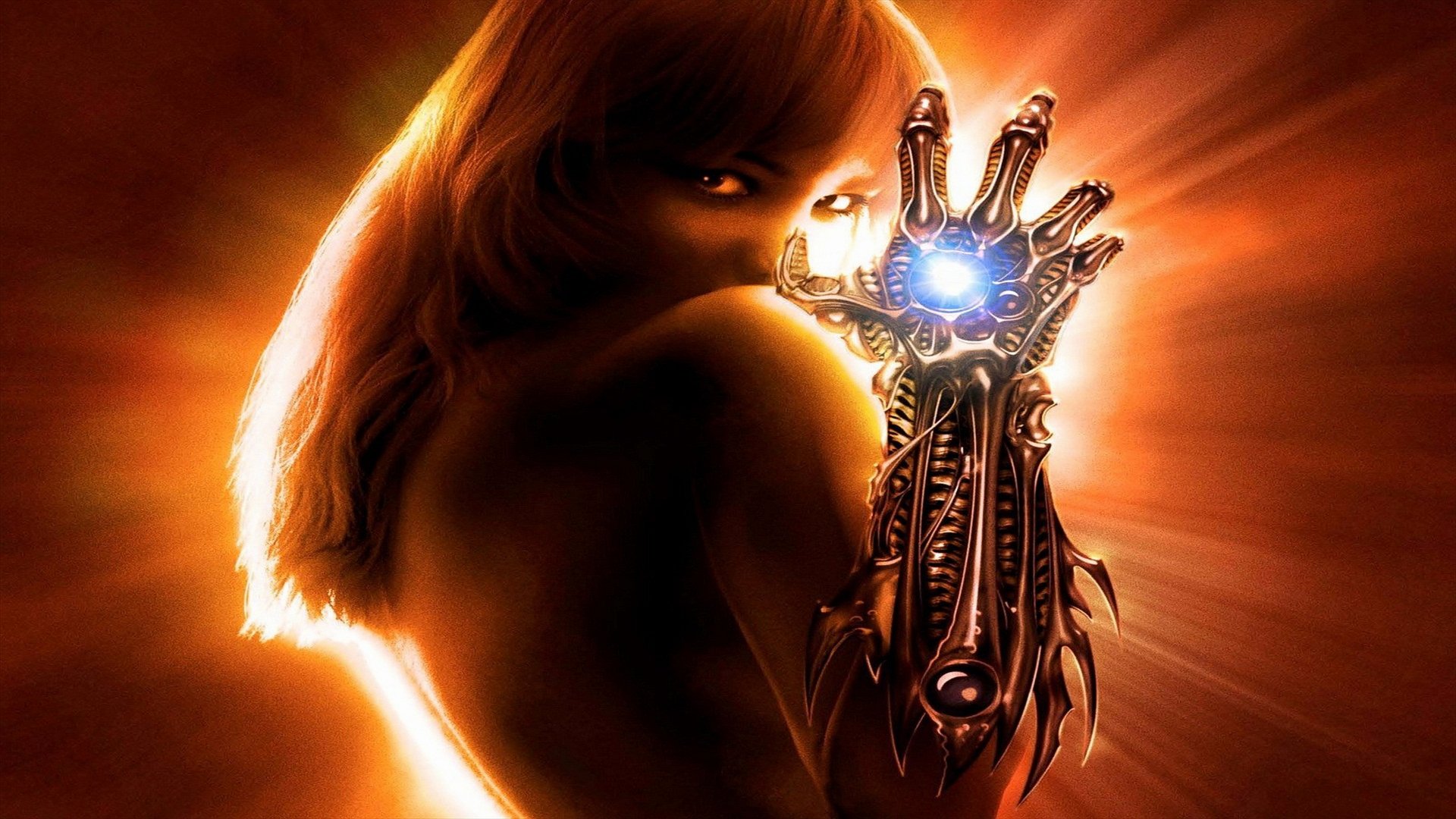 A dynamic HD wallpaper featuring a redhead witch from the comic Witchblade, showcasing her powerful armored hand glowing with energy against a radiant background.