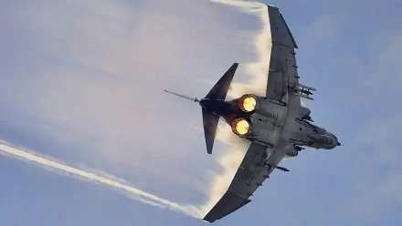 A high-definition wallpaper showcasing a McDonnell Douglas F-4 Phantom II jet, soaring through the sky with afterburners ignited, creating dynamic vapor trails.