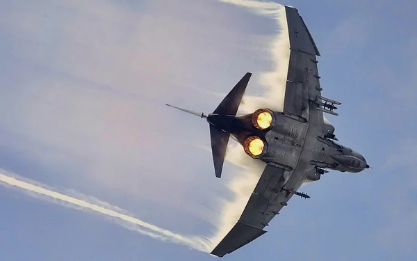 A high-definition wallpaper showcasing a McDonnell Douglas F-4 Phantom II jet, soaring through the sky with afterburners ignited, creating dynamic vapor trails.