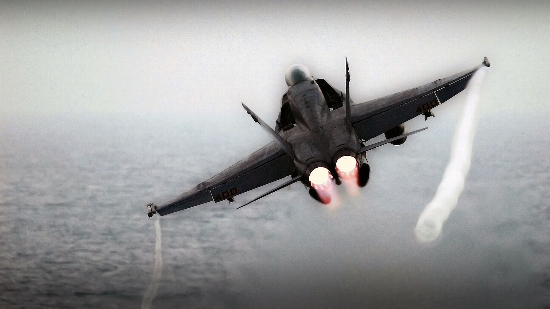 Military jet fighter soaring through the skies as a striking desktop wallpaper.