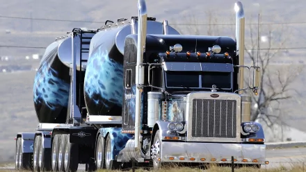 A striking HD desktop wallpaper featuring a sleek truck with intricate designs, showcasing its powerful presence and impressive detailing against a scenic background.