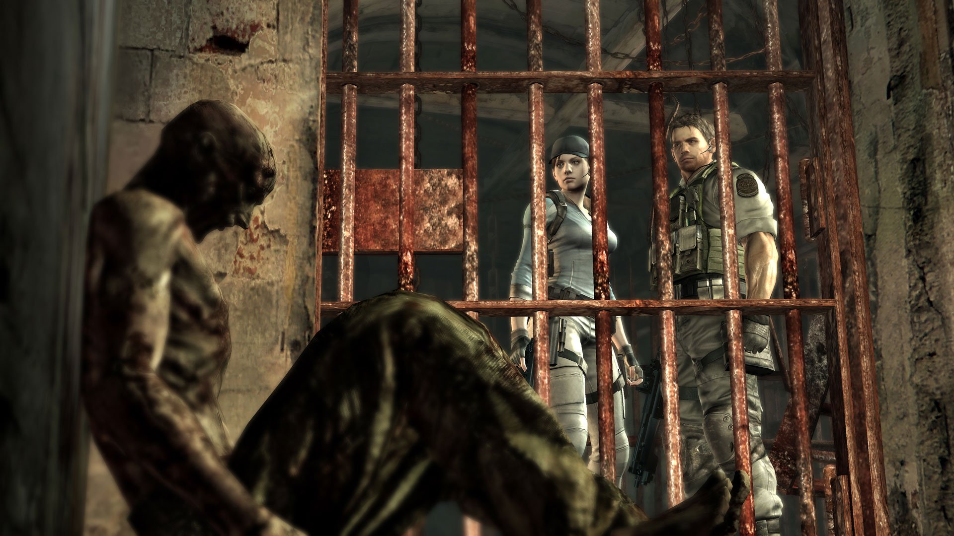 HD PC wallpaper featuring Chris Redfield and Jill Valentine from Resident Evil 5 standing behind prison bars with a zombie in the foreground.