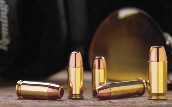 HD PC desktop wallpaper/background: man-made copper-and-brass bullets arranged on a wooden surface, shallow depth of field with warm, glossy reflections.