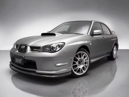 HD desktop wallpaper featuring a silver Subaru Impreza, showcasing its sporty design and distinctive front grille in a studio setting.