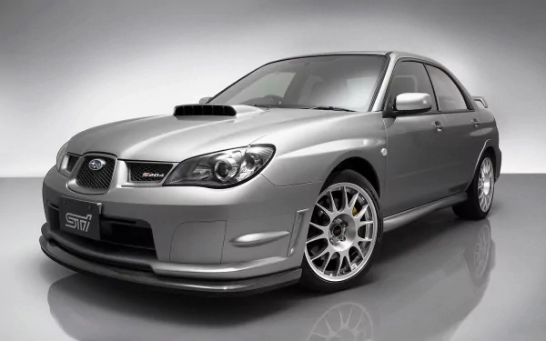 HD desktop wallpaper featuring a silver Subaru Impreza, showcasing its sporty design and distinctive front grille in a studio setting.