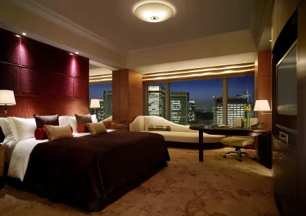 Crisp HD desktop wallpaper of a stylish penthouse room featuring modern furniture and a cityscape view at night.