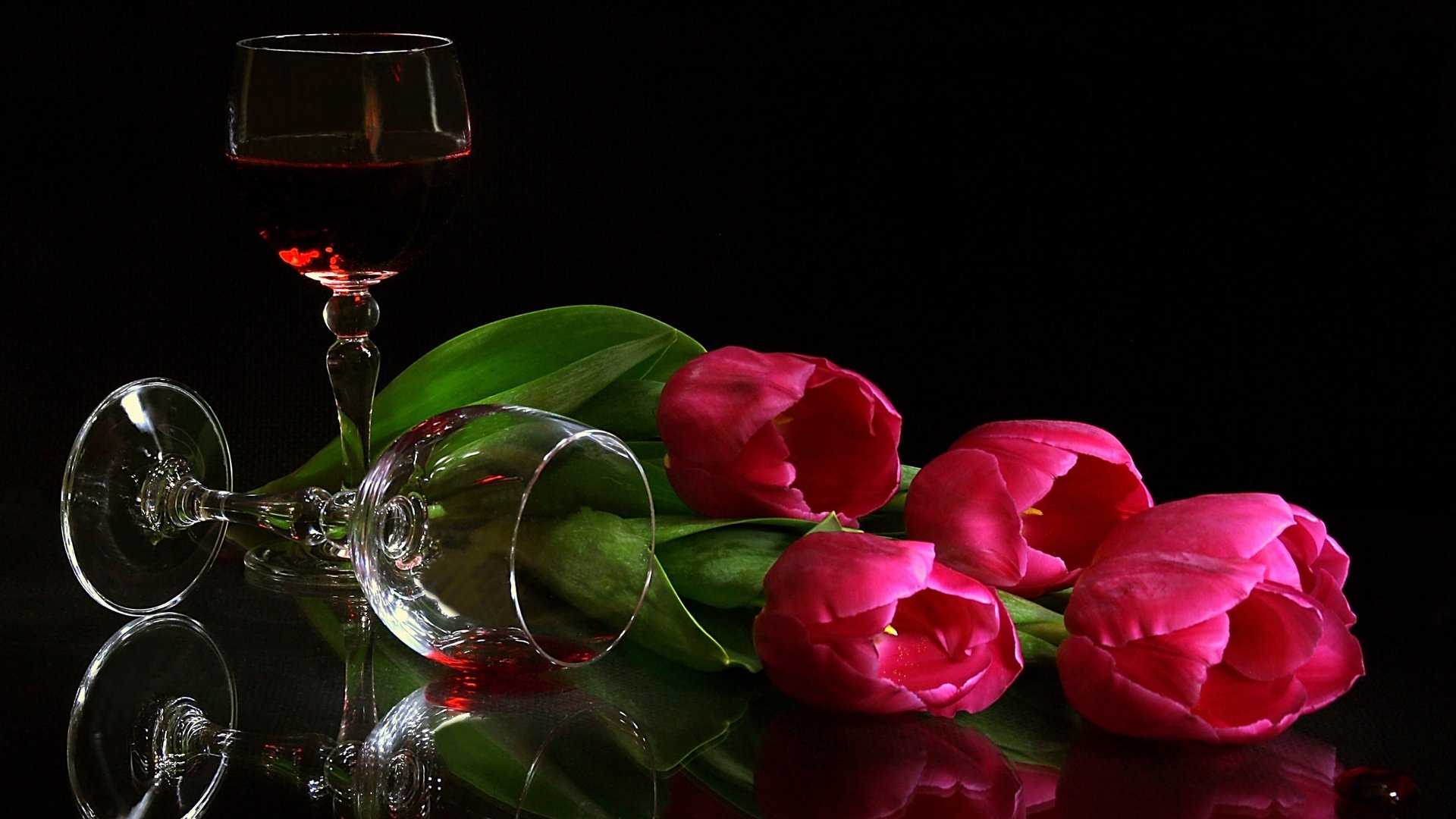 HD still life photography of vibrant pink tulips and two wine glasses on a reflective surface, designed as a PC desktop wallpaper and background.