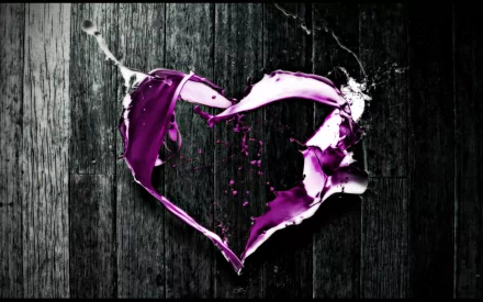 Artistic HD desktop wallpaper featuring a vibrant purple heart shape formed by splashing paint against a dark wooden background, symbolizing love.