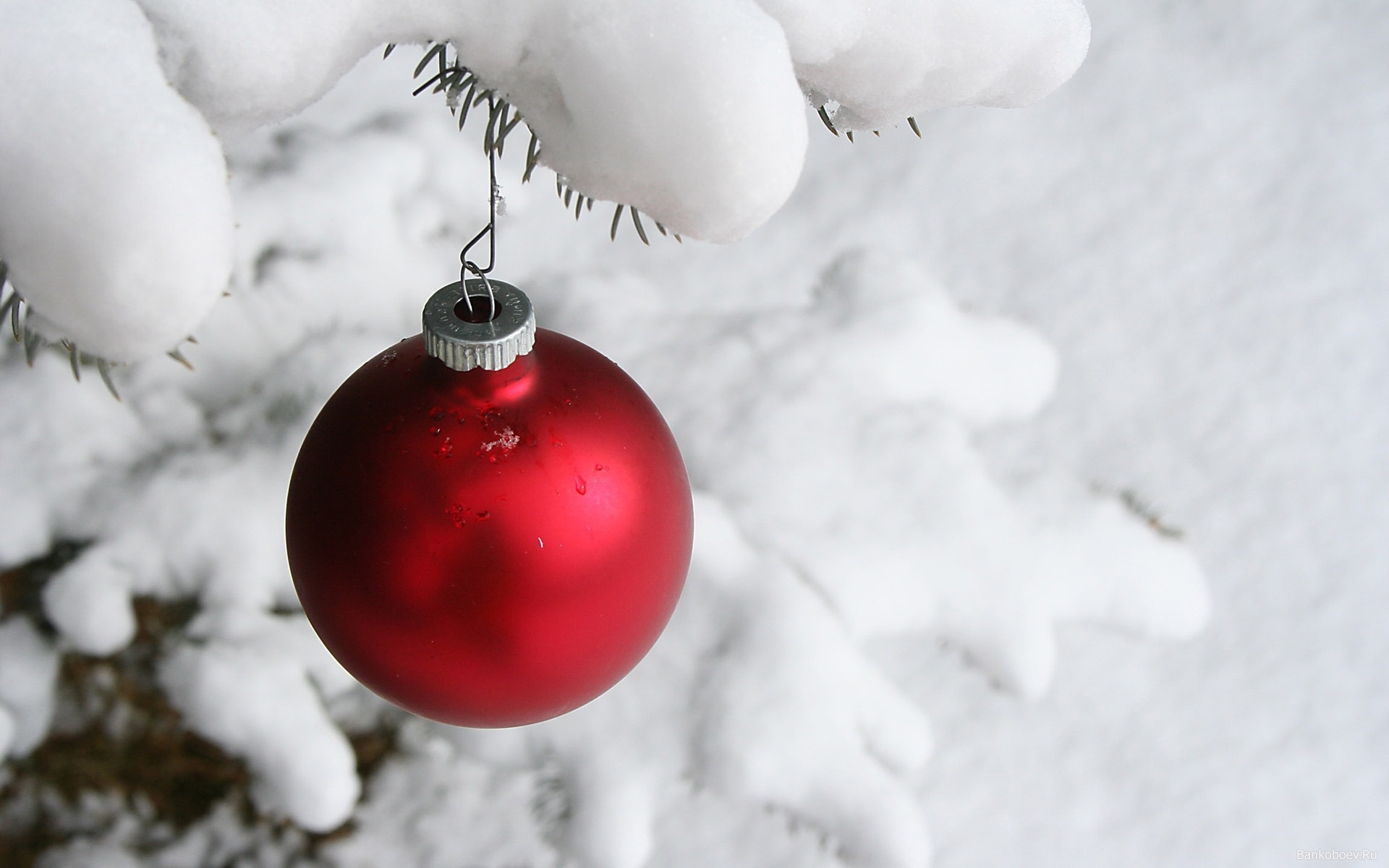 Christmas ornaments on snowy winter background