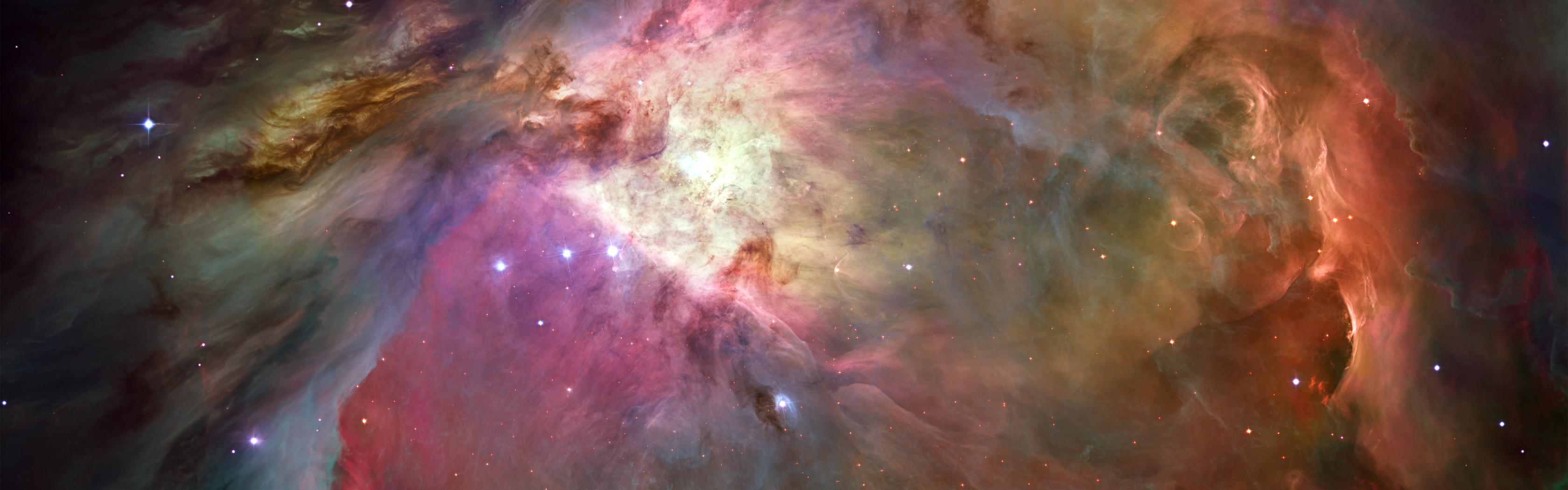Vibrant colors swirl in the majestic Orion Nebula, a captivating space marvel.